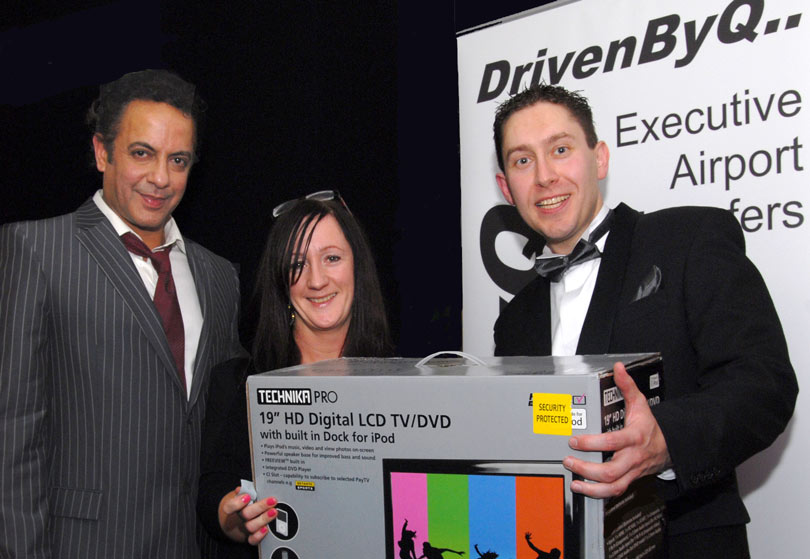 Picture of Ray Squire giving away a flat screen TV to a DrivenByQ prize winner